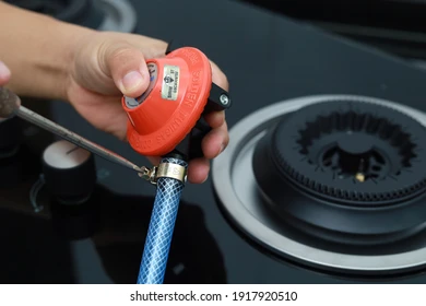 Technician checking LPG gas regulator and pipe